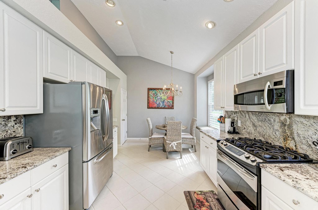 a kitchen with stainless steel appliances and white cabinets