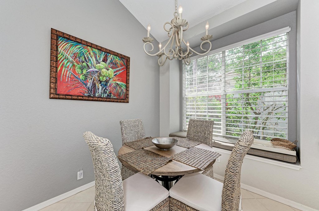a dining room with a table and chairs and a window
