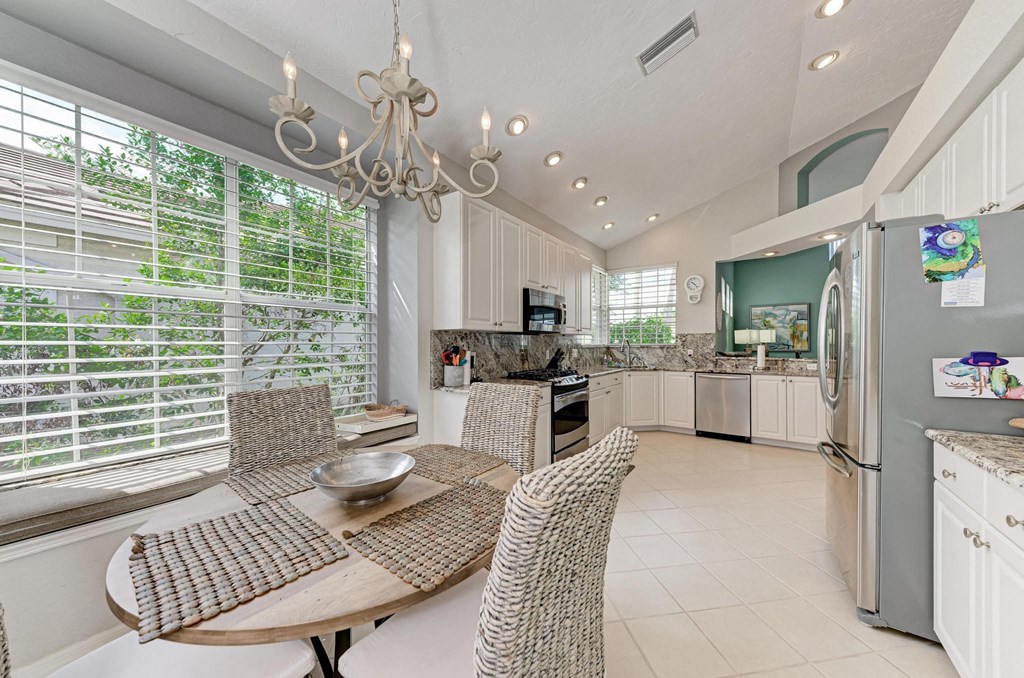 a dining room with a table and chairs next to a kitchen