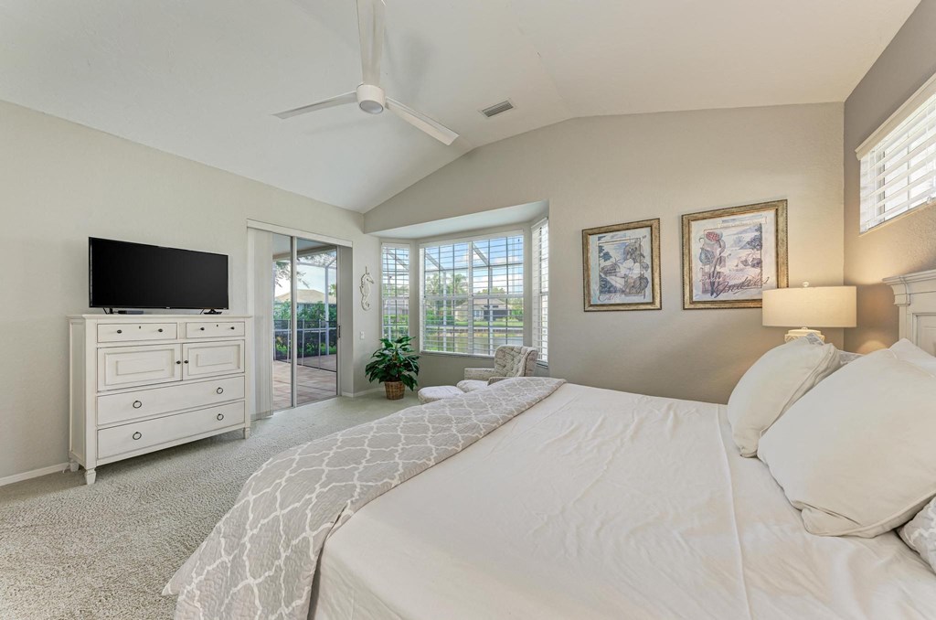 a bedroom with a large bed and a tv