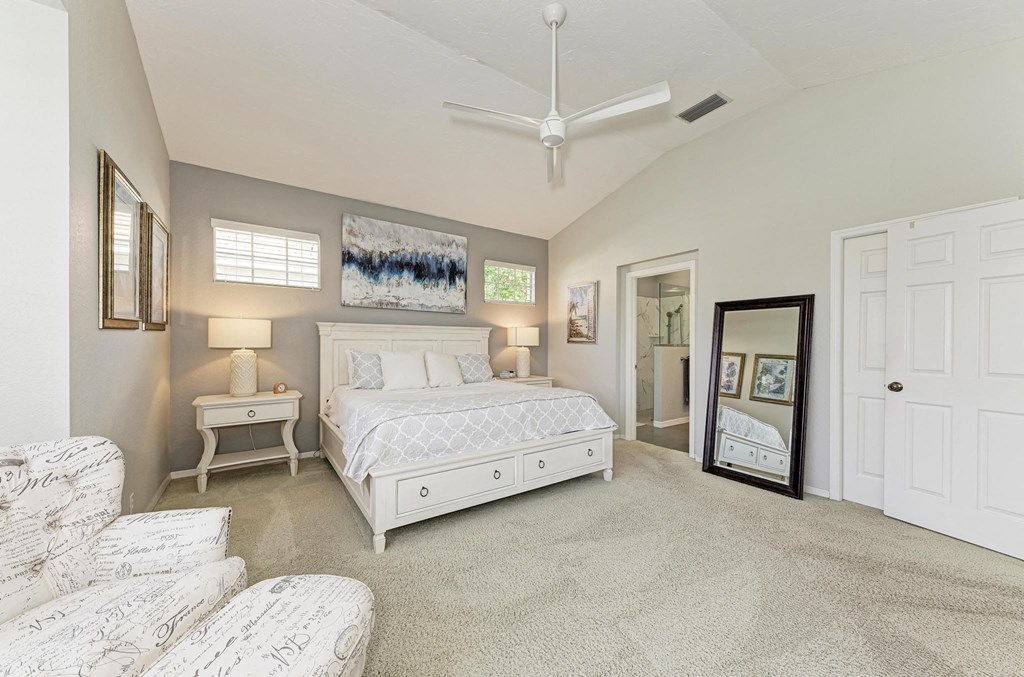 a white bedroom with a white bed and a white closet