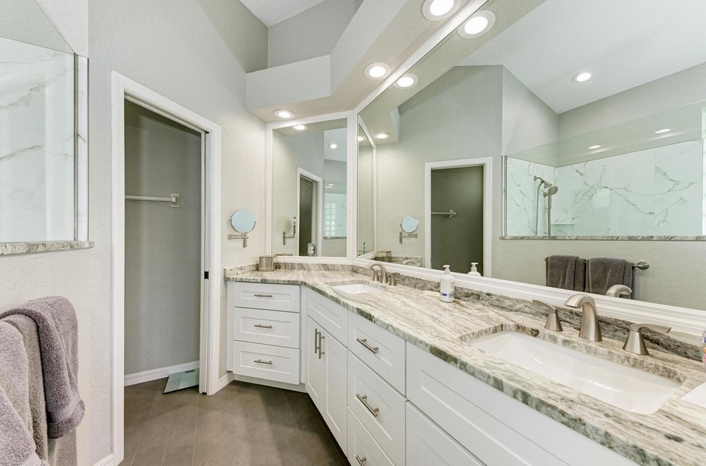 a bathroom with two sinks and a large mirror