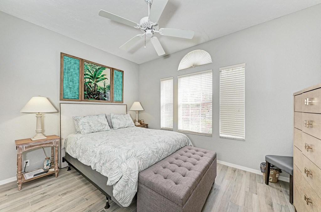 a bedroom with a bed and a ceiling fan