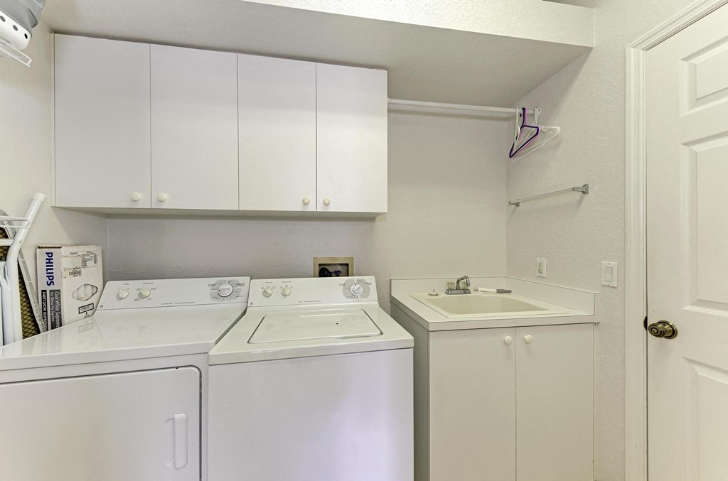 a white kitchen with white appliances and white cabinets