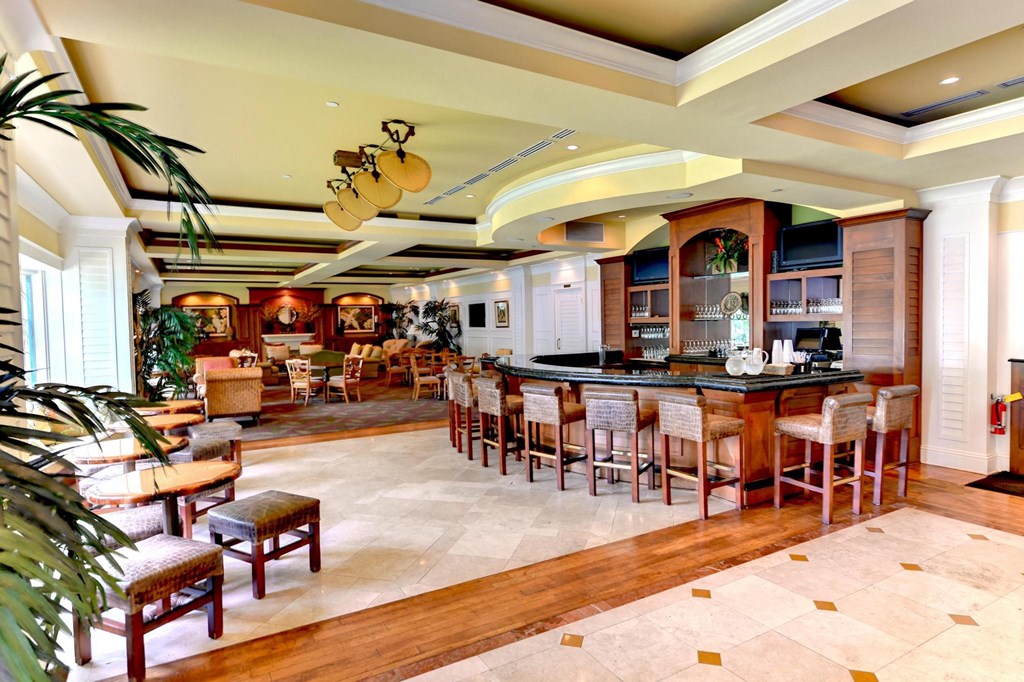 a large lobby with a bar and tables