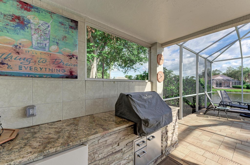 a kitchen with a counter top and a large window