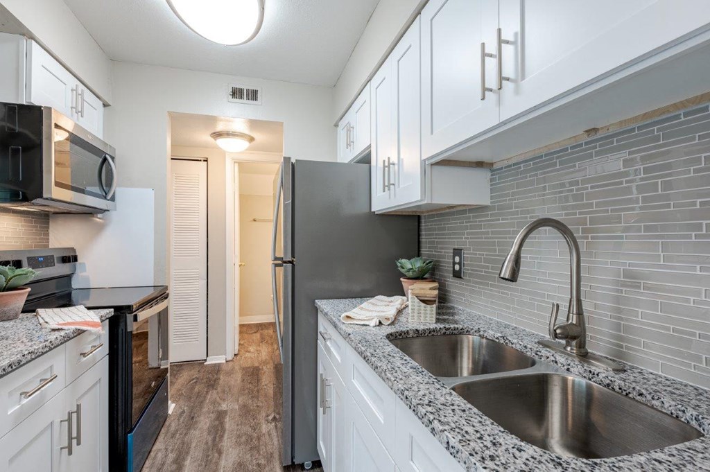 a kitchen with a sink and a refrigerator