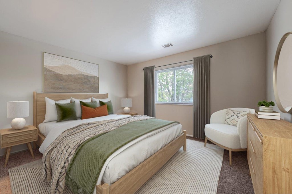 a bedroom with a bed and a chair and a window