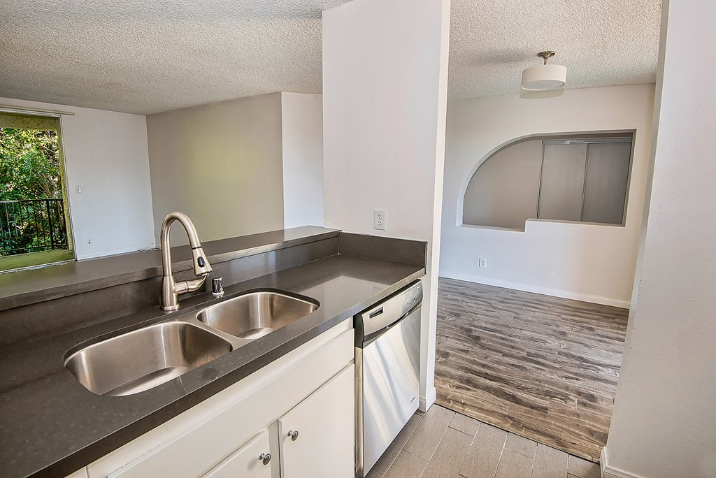 an empty kitchen with a sink and a window