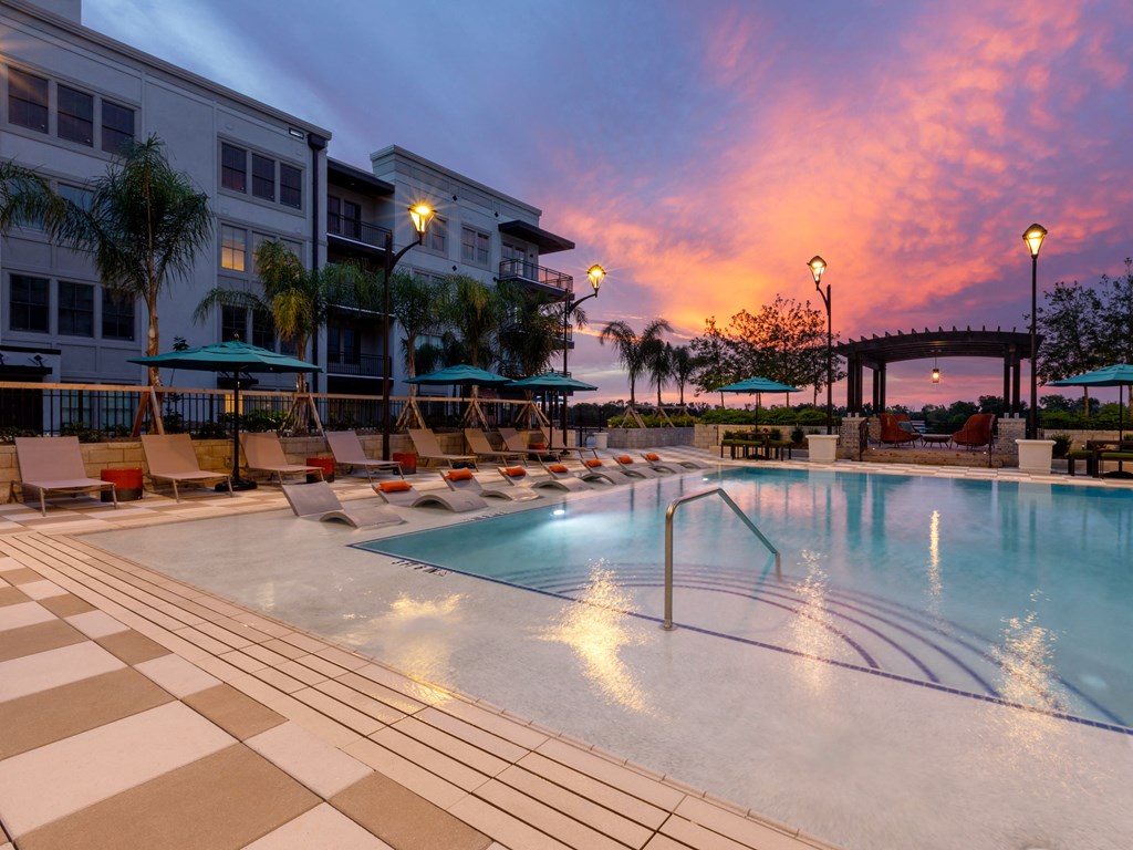 a swimming pool at sunset at the resort at longboat key club
