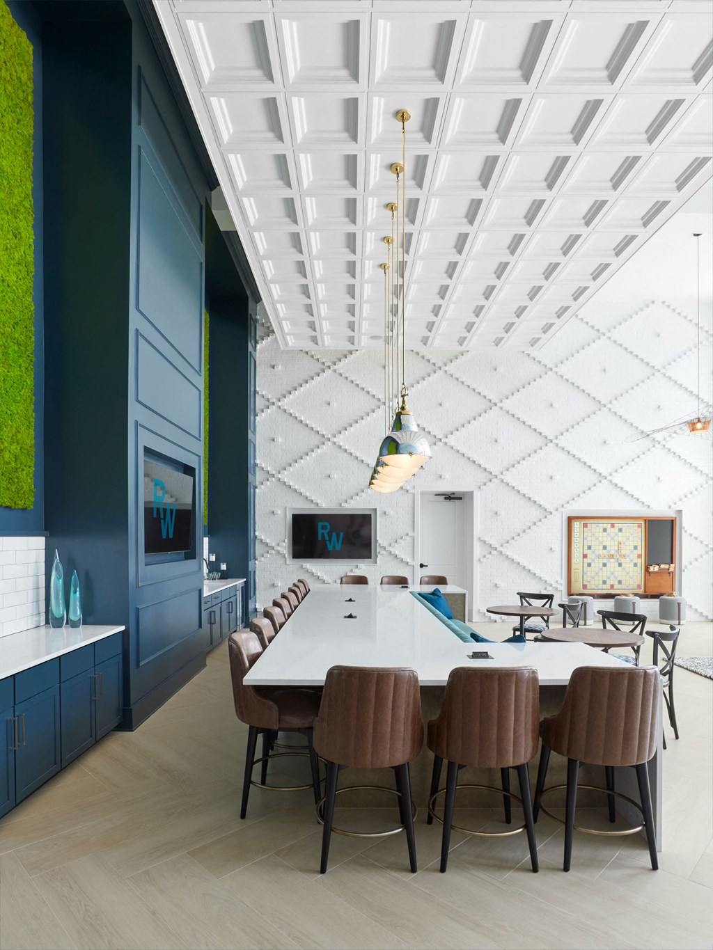 a dining room with a long white table and chairs and a blue wall and ceiling