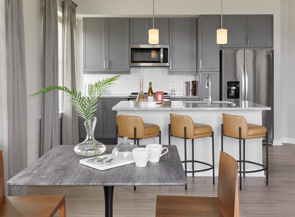 a kitchen and dining area with a table and chairs