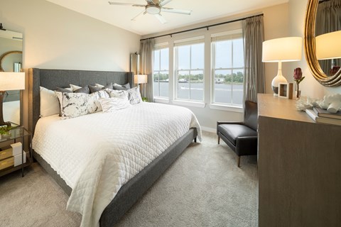 a bedroom with a large bed and a window