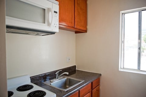 an empty kitchen with a sink and a microwave