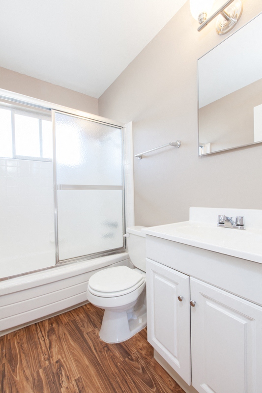 a bathroom with a toilet and a shower and a sink
