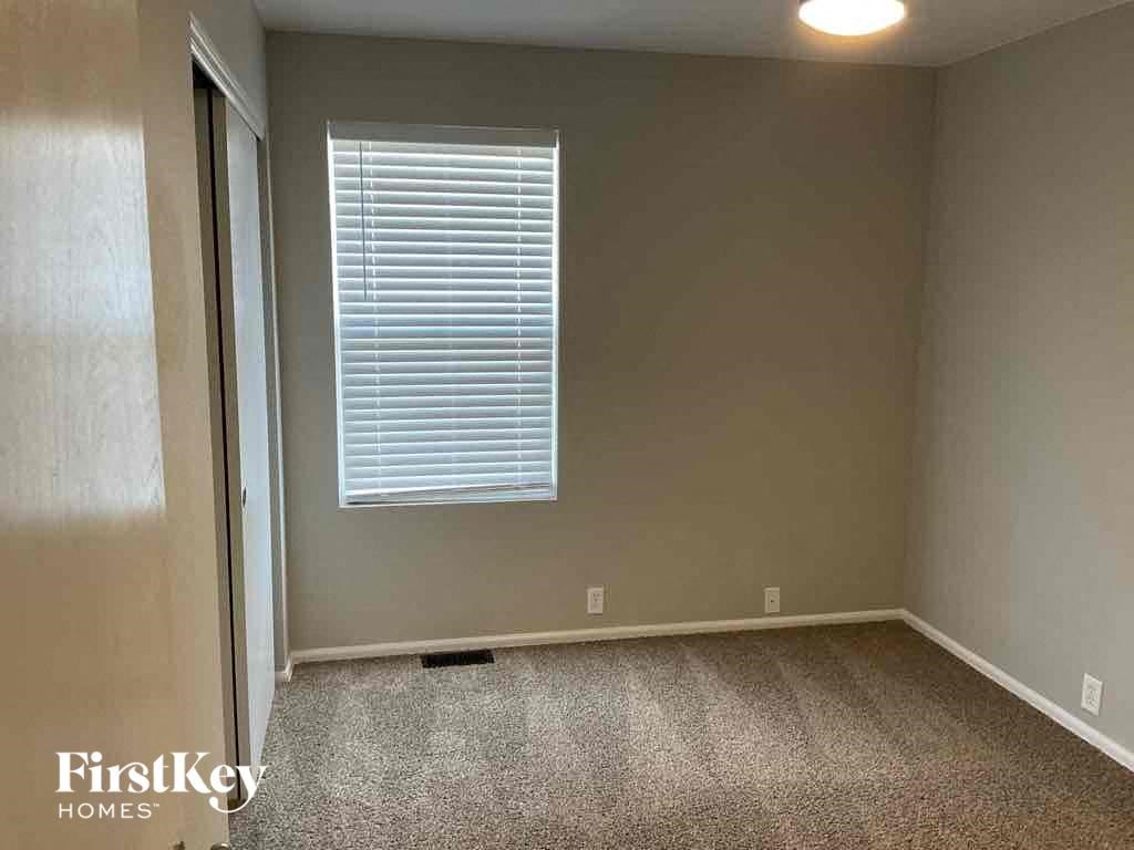 an empty room with a window and a door