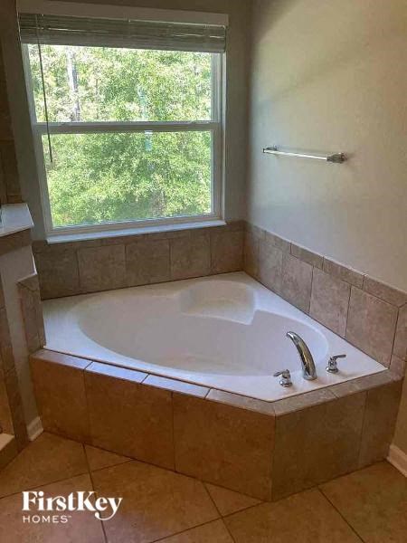a jacuzzi tub in a bathroom with a window