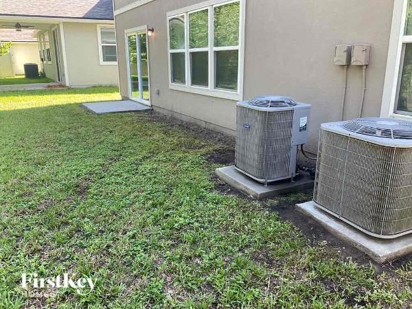 a backyard with a house and a radiator and a heater in the grass
