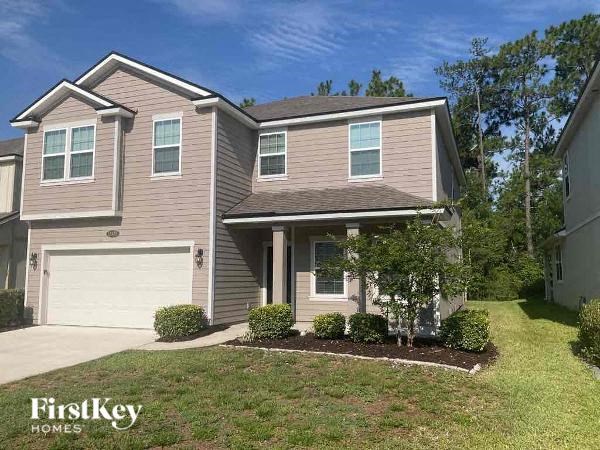 a house with a driveway and a garage door