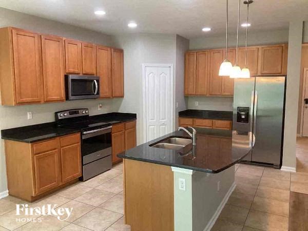 a kitchen with stainless steel appliances and wooden cabinets
