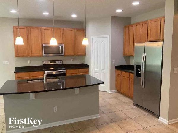 a kitchen with a counter top and a refrigerator