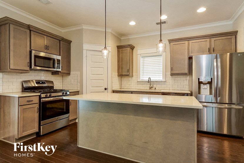 a kitchen with stainless steel appliances and a white counter top