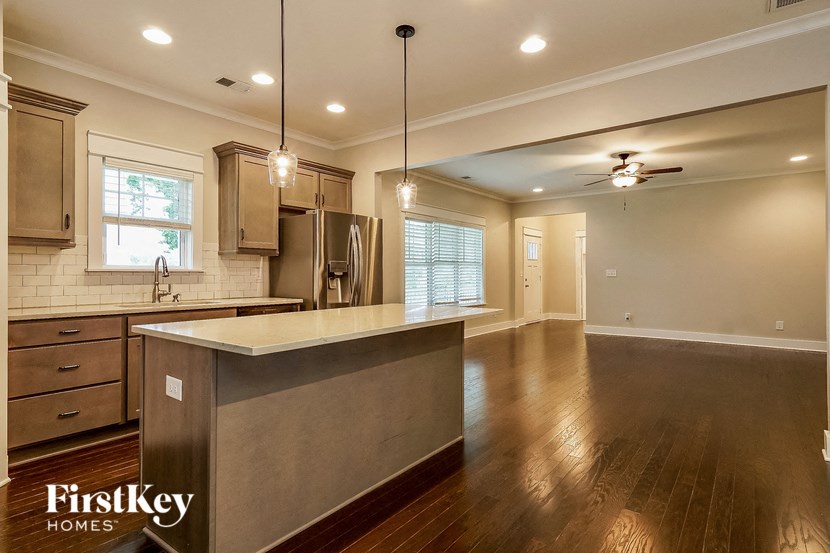 an empty kitchen with a counter top in the middle