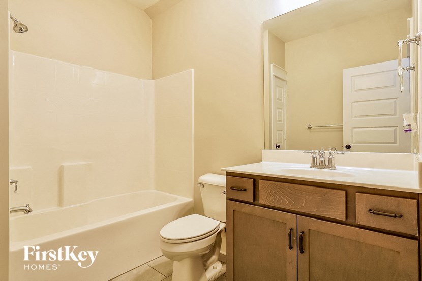 a bathroom with a sink toilet and a bath tub