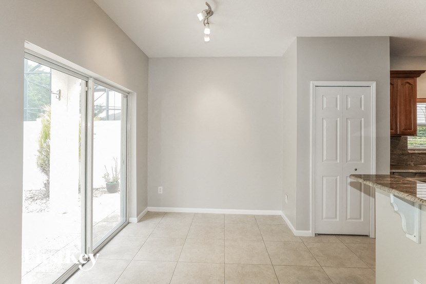 an empty kitchen with a sliding glass door to a patio