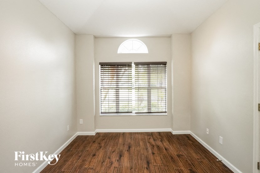 a living room with wood floors and a window