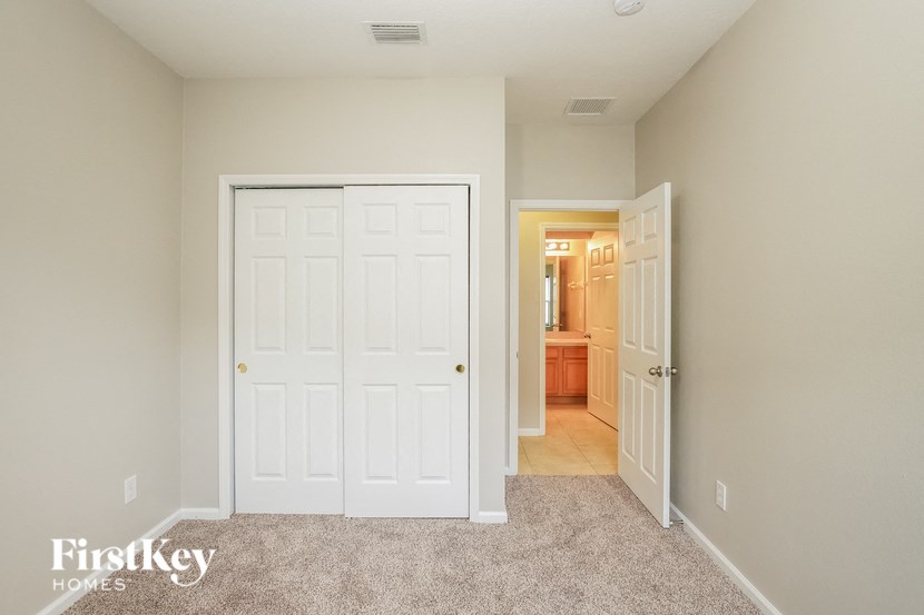a bedroom with two closets and a door to a bathroom