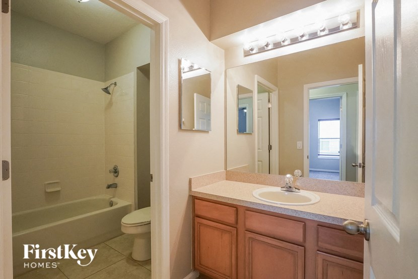 a bathroom with a sink and a shower and a toilet