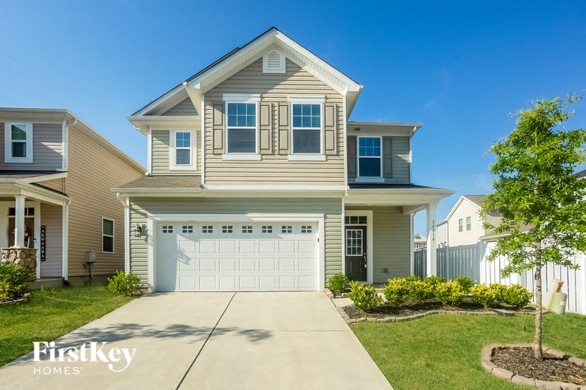 a beige house with a white garage door