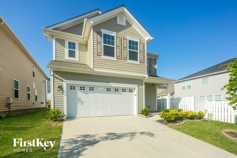 a tan house with a white garage door