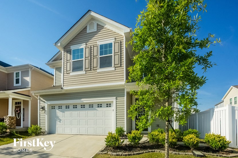 a tan house with a white garage door