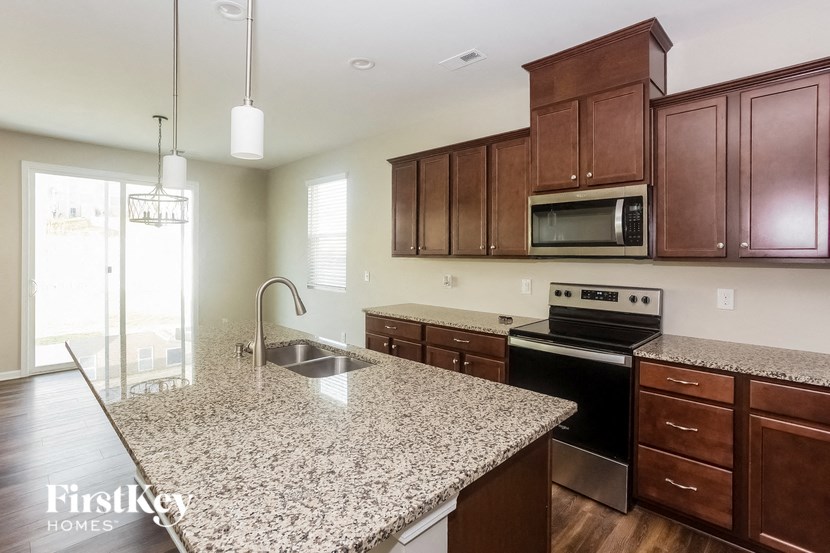 a kitchen with wooden cabinets and granite counter tops