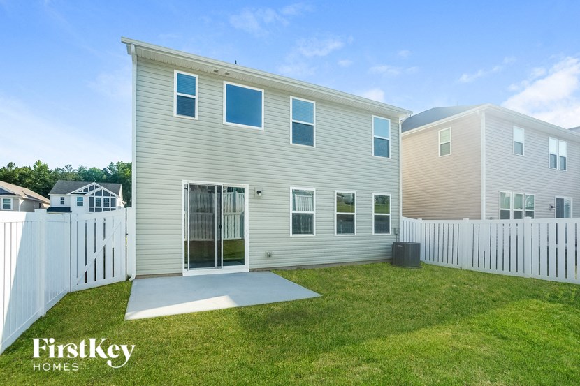 a white house with a yard and a white fence