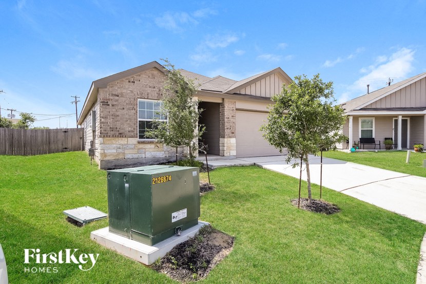 a home with a green utility box in the front yard