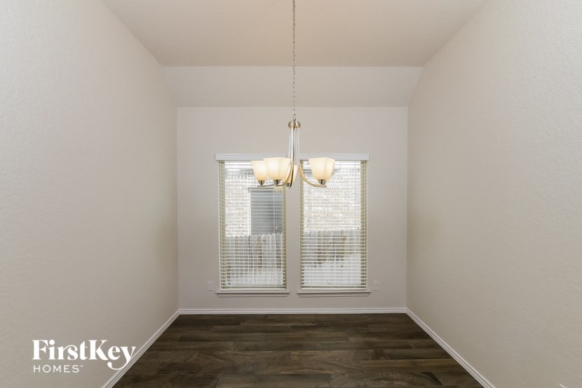 a living room with a window and a chandelier