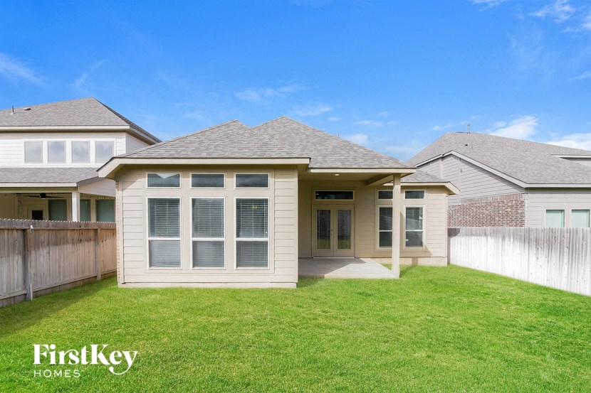 a home with a lawn and a fence