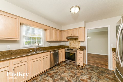 a kitchen with wooden cabinets and stainless steel appliances