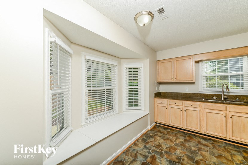 a kitchen with wooden cabinets and a sink and a window