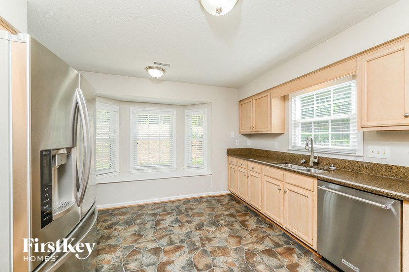 a kitchen with a stainless steel refrigerator and a sink