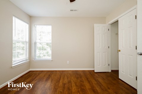 the living room of a home with wood floors and a white door