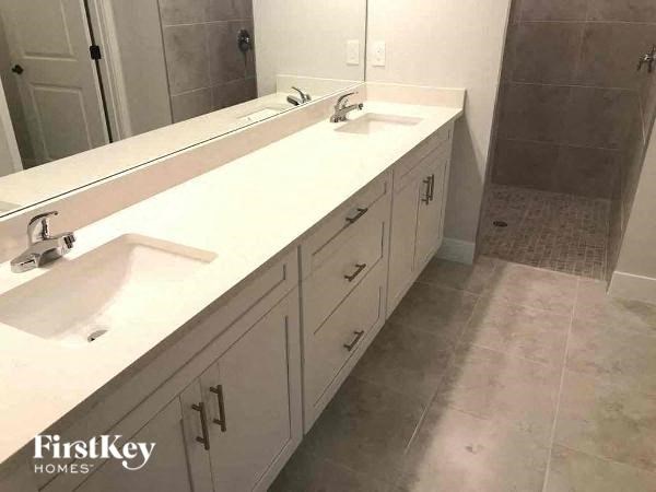 a bathroom with two sinks and a mirror