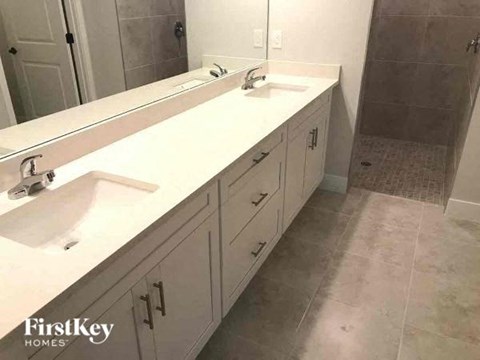 a bathroom with two sinks and a mirror