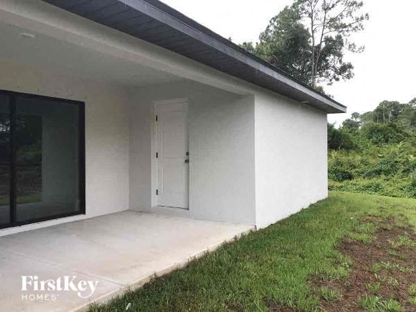 a white house with a door on the side of it