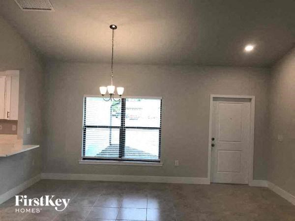 an empty living room with a window and a door
