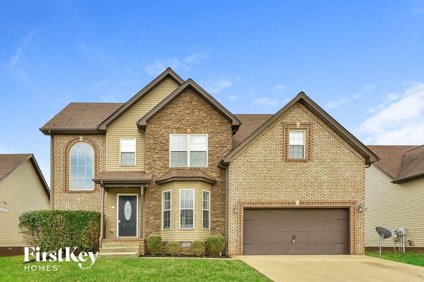 a brick house with a garage and a blue sky