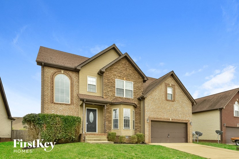 a large brick house with a blue sky in the background